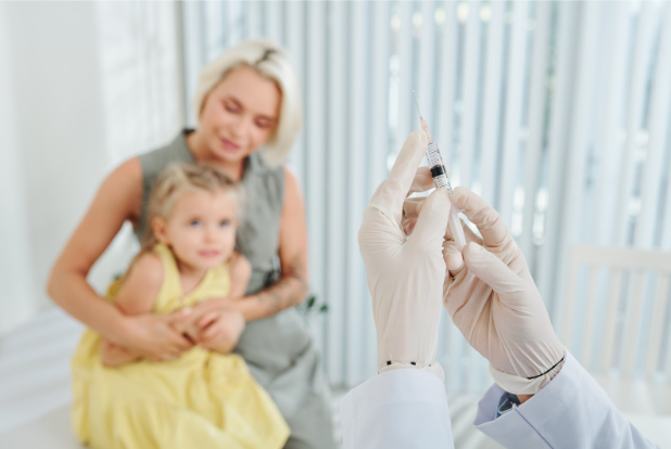 A mother and her anxious child waiting to receive a needle injection
