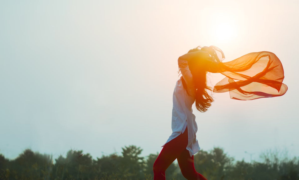 woman spreading her hair during sunset